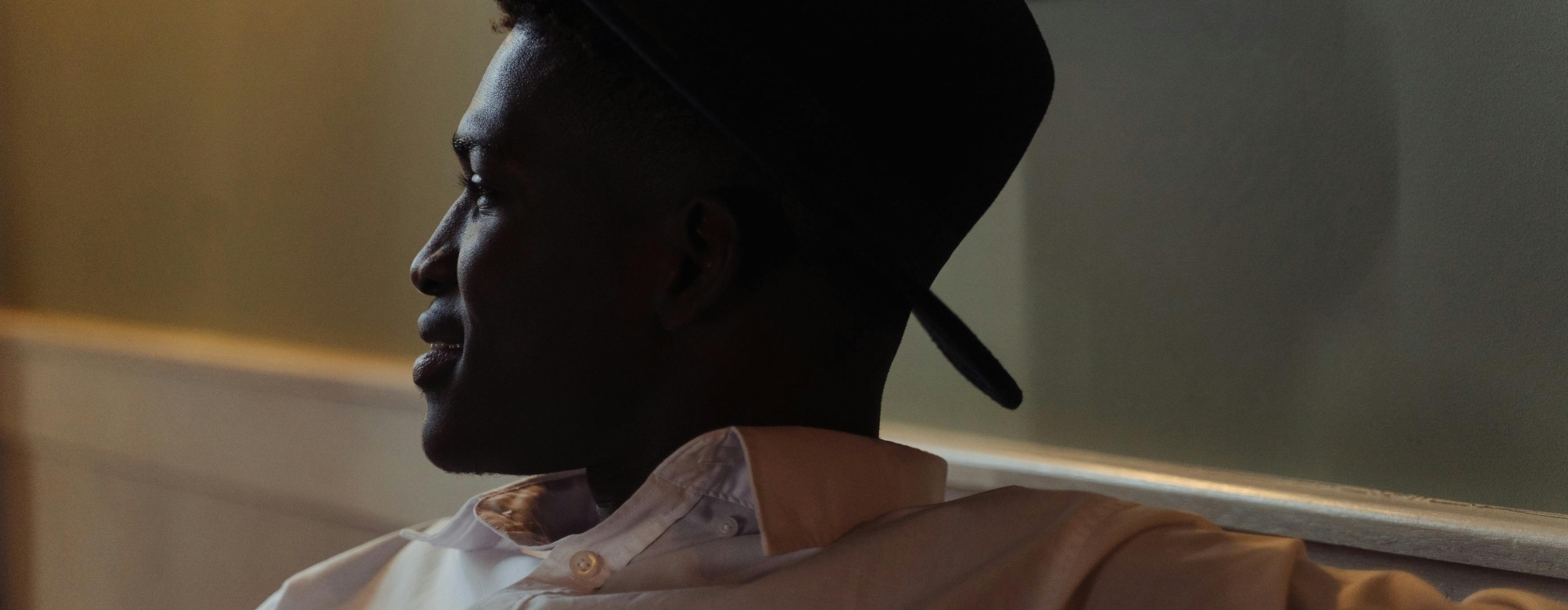 photo of young black man inside an apartment smiling